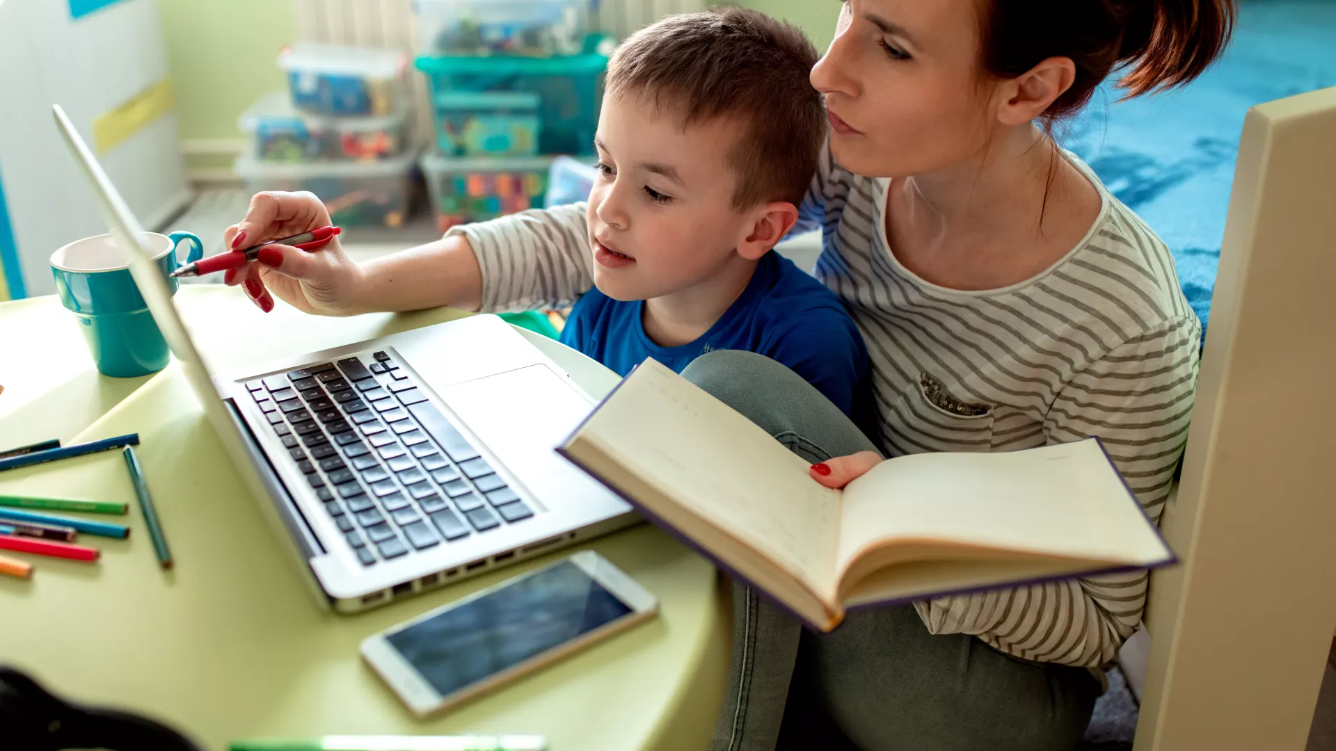 Parent and child sat with laptop