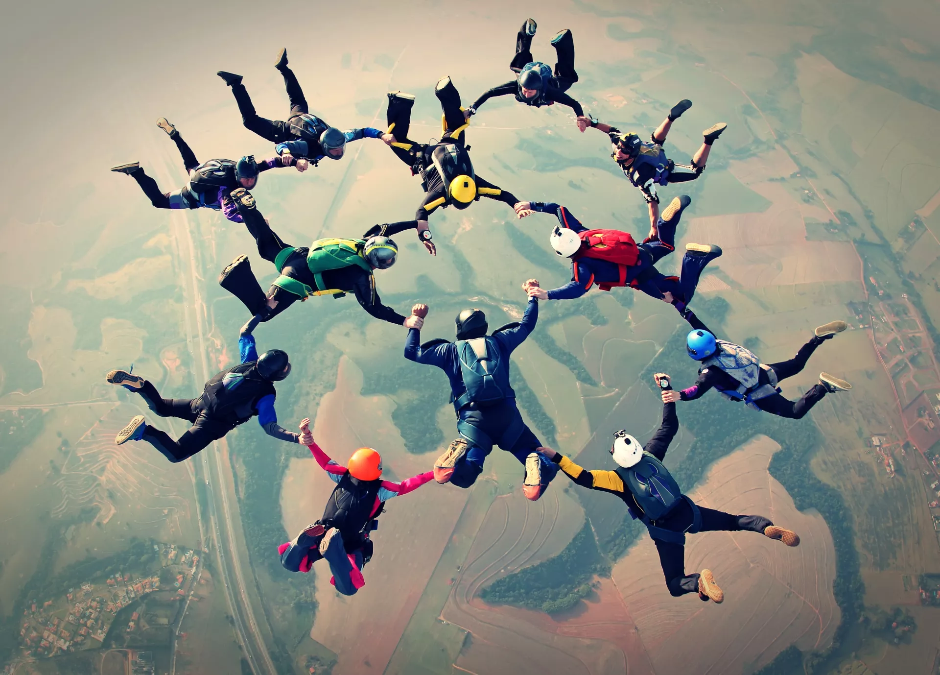 Image of skydivers linking hands