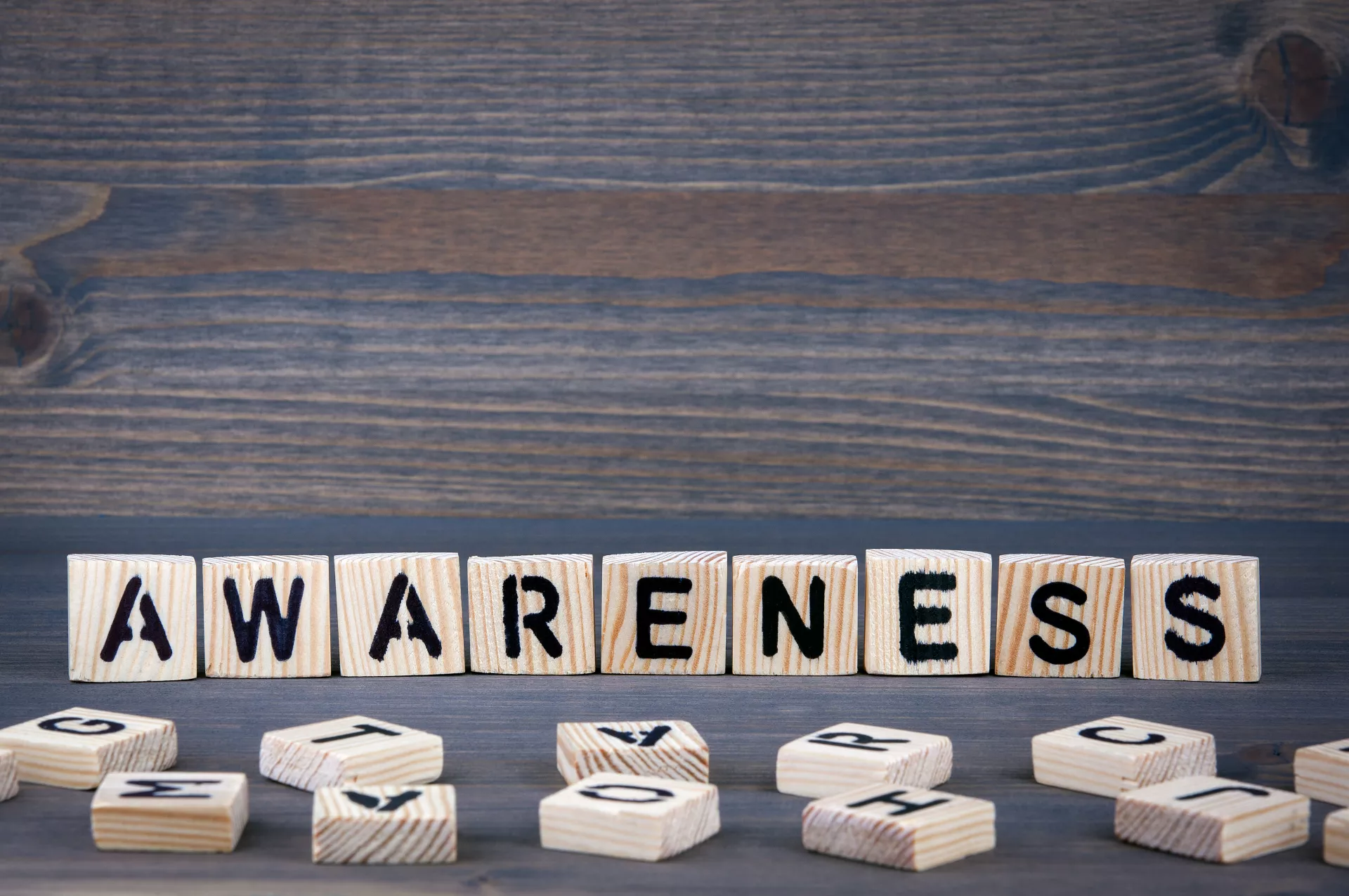 Wooden blocks spelling 'AWARENESS'