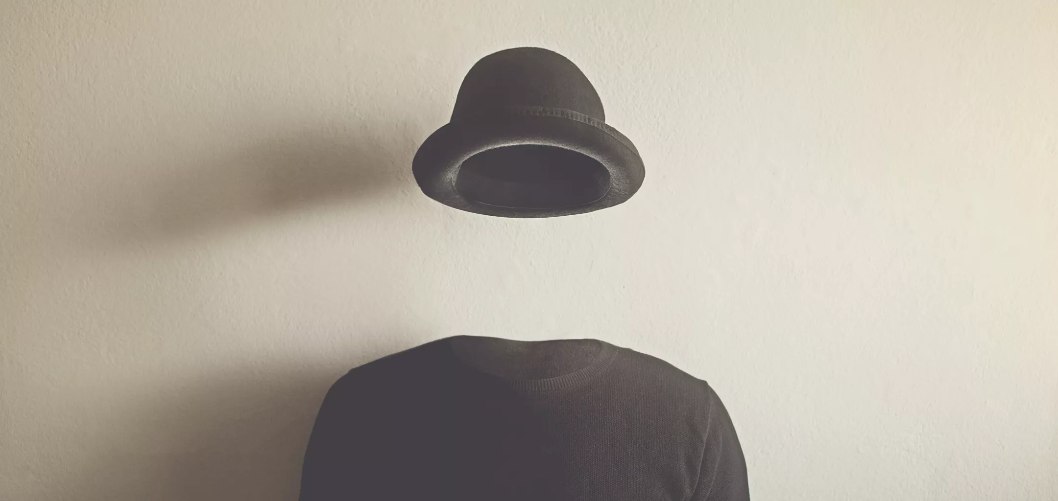 Image of an invisible person wearing a top and hat, with no visible face