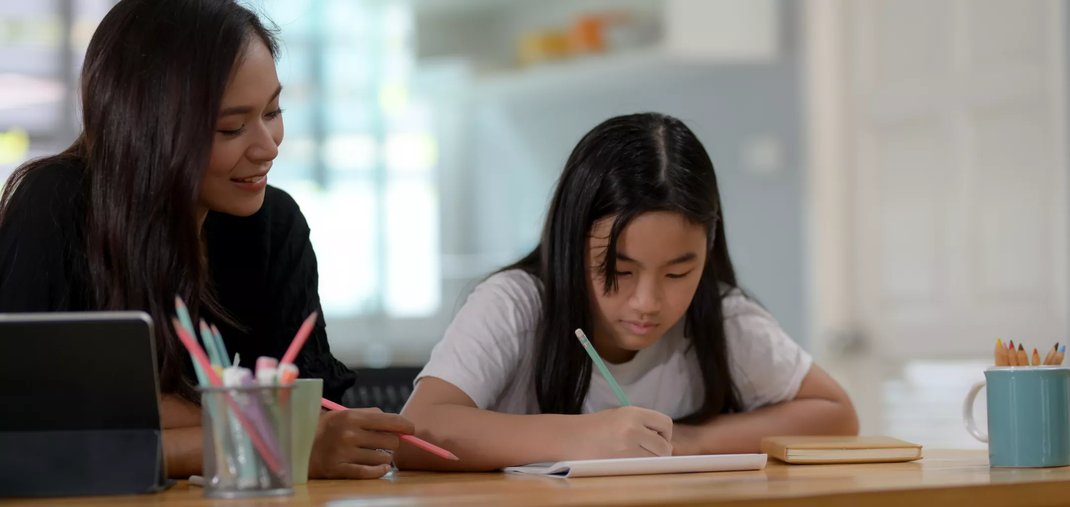 Teacher supporting student in classroom