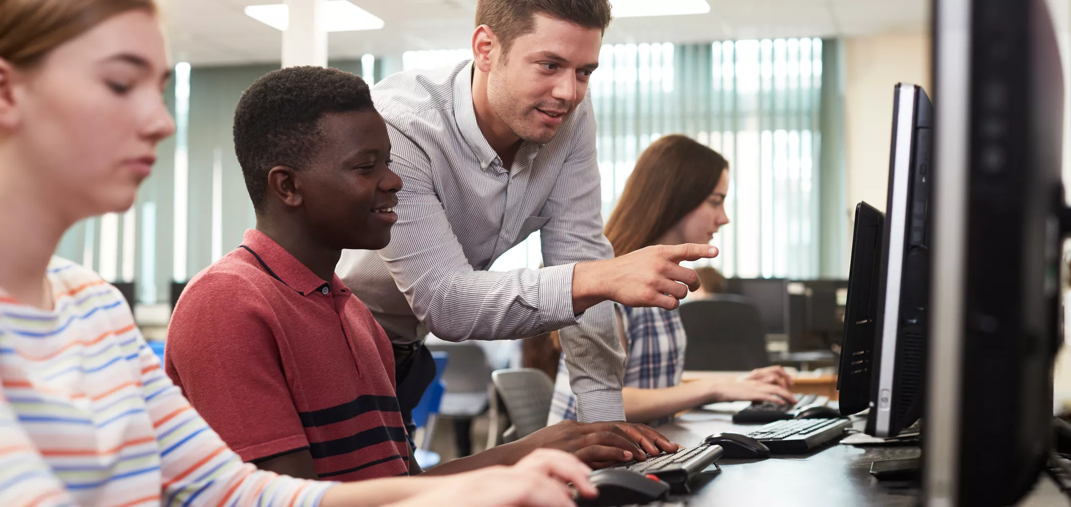 Teacher helping student in classroom